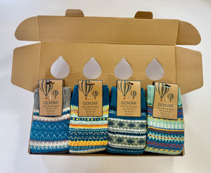 4 pairs of blue toned, Fairisle patterned, cosy crew socks for men in a cardboard gift box