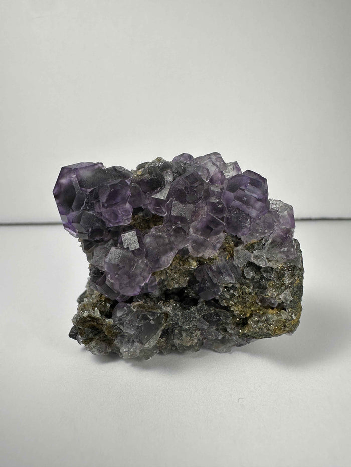 Purple Dodecahedral Fluorite with Calcite on matrix - Smokin Resin Company