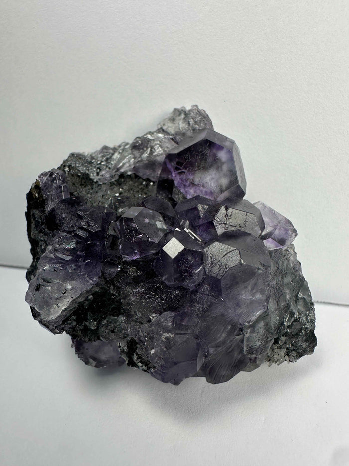 Purple Dodecahedral Fluorite with Calcite on matrix - Smokin Resin Company