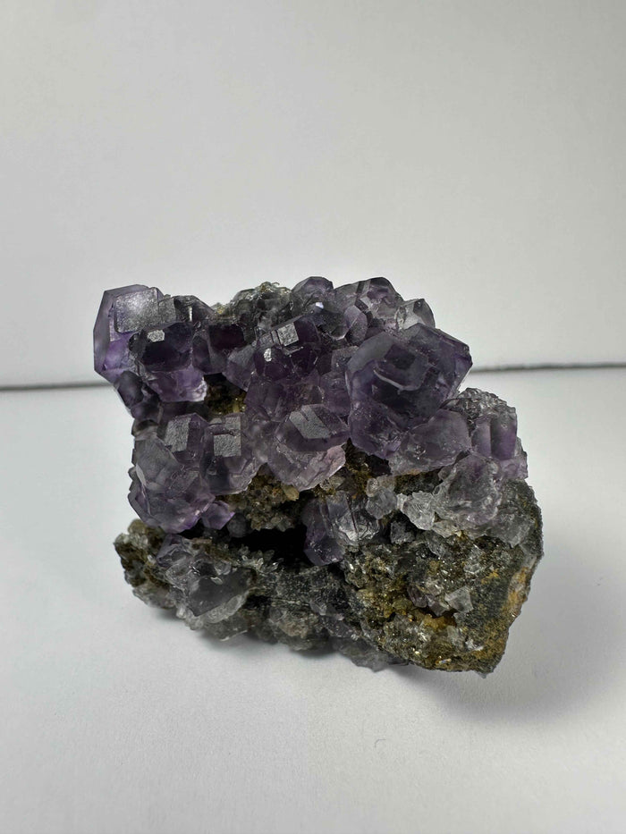 Purple Dodecahedral Fluorite with Calcite on matrix - Smokin Resin Company