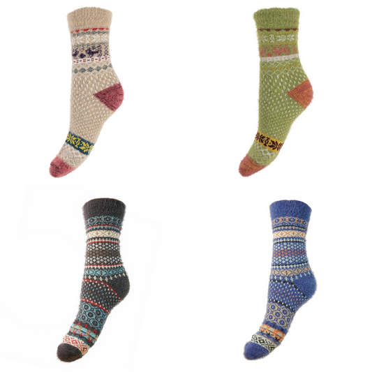 Four patterned socks in different colors with a Fairisle pattern on a white background